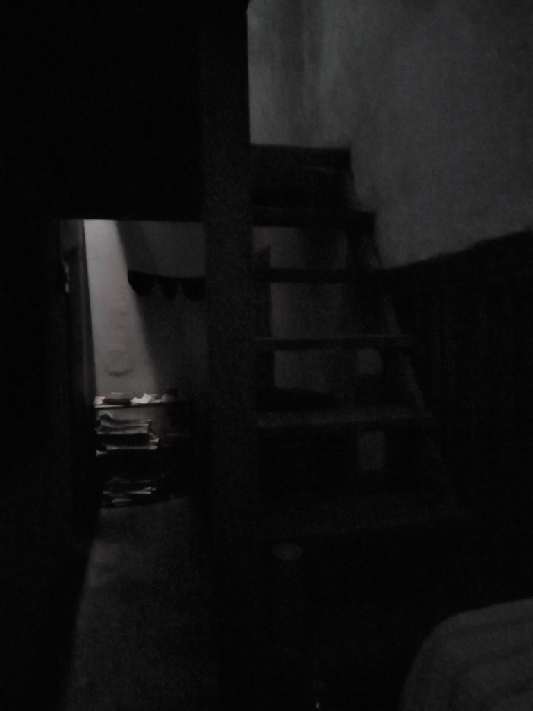 The dark staircase leading to the first-floor room
